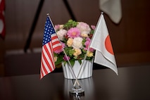 U.S. and Japan protocol flags sit next to a bundle of flowers on a table during a meeting between U.S. Air Force Master Sgt. Cesar Ventura and two Japan Air Self-Defense Force warrant officers with the 3rd Air Wing at Misawa Air Base, Japan, Feb. 14, 2018. The three met to discuss one of the warrant's retirement plans. This meeting reflects a very common theme for the three men who over the past four years have become "like family." Ventura is a vertical inspections planner with the 35th Fighter Wing's Inspector General's office and hails from Los Angeles, California. (U.S. Air Force photo by Tech. Sgt. Benjamin W. Stratton)