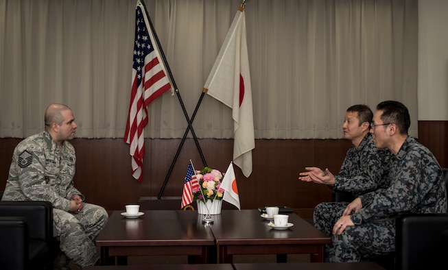 U.S. Air Force Master Sgt. Cesar Ventura, left, a 35th Fighter Wing inspector general vertical inspections planner, and Japan Air Self-Defense Force Warrant Officers Junji Miura, center, the 3rd Air Wing command chief, and Tsuyoshi Endo, right, the former 6th Air Defense Missile Group chief and Senior Noncommissioned Officer Association president, discuss plans to celebrate Endo's retirement next month with a small family gathering during a "tea time" meeting in the 3rd AW's headquarters at Misawa Air Base, Japan, Feb. 14, 2018. Ventura's deep understanding of his host nation's language and culture cemented him relationships with two life-long friends who now consider him, "like family." (U.S. Air Force photo by Tech. Sgt. Benjamin W. Stratton)