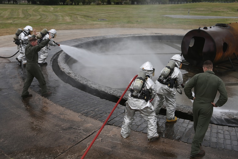 MCAS FUTENMA, OKINAWA, Japan – Aircraft rescue and firefighting Marines spray the training pit Feb. 10 during a wet run training exercise on Marine Corps Air Station Futenma, Okinawa, Japan.
