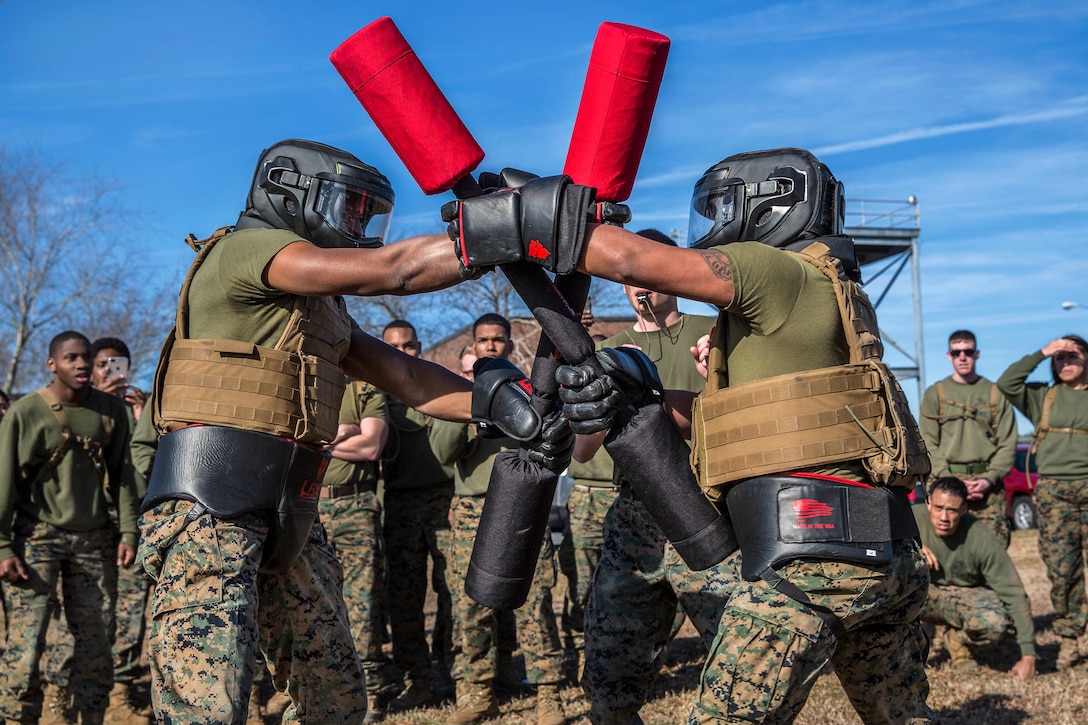 Two Marines compete against each other in a pugil stick match.