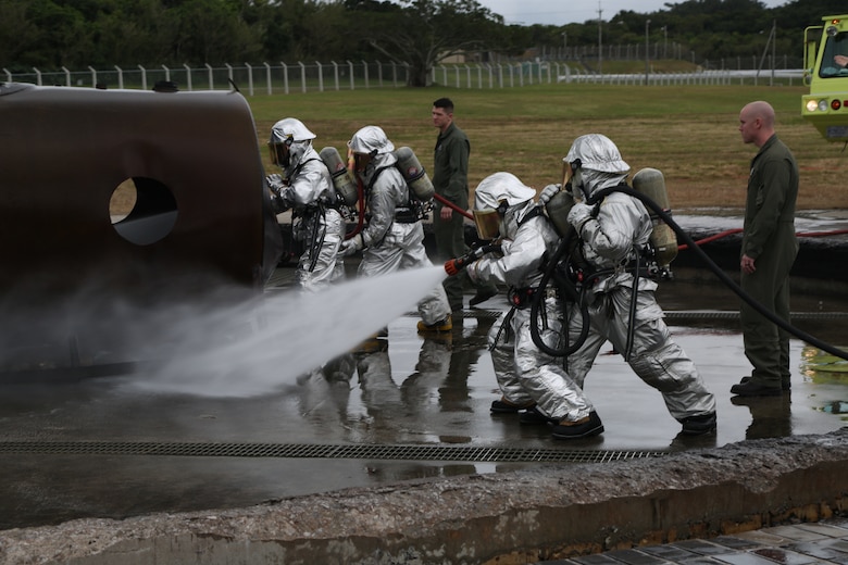 MCAS FUTENMA, OKINAWA, Japan – Aircraft rescue and firefighting Marines spray the training pit during a wet run training exercise Feb. 10 on Marine Corps Air Station Futenma, Okinawa, Japan.
