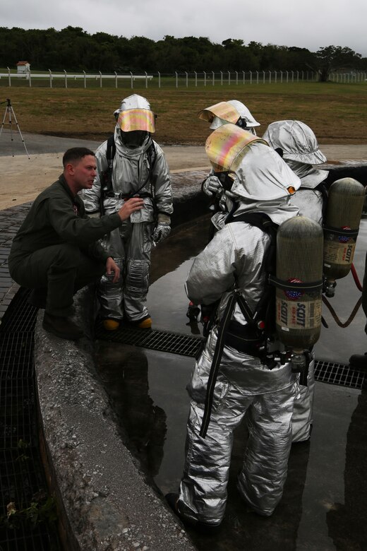 MCAS FUTENMA, OKINAWA, Japan – Sgt. Andrew Busby briefs the aircraft rescue and firefighting Marines Feb. 10 during a wet run training exercise on Marine Corps Air Station Futenma, Okinawa, Japan.
