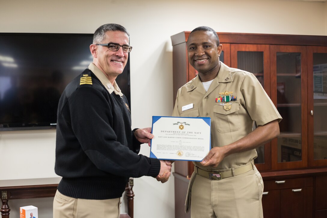 Navy Lt. Ismael Tounkara, assigned to Naval Supply Systems Command Weapon Systems Support in Mechanicsburg, Pa., was recognized in an award ceremony, Jan. 19, 2018, by Navy Capt. Rudy Geisler, deputy commander for maritime. Navy photo by Dorie Heyer