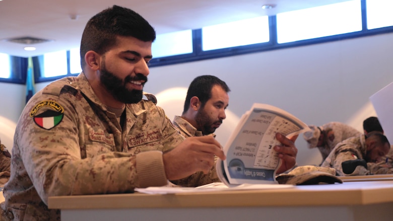 Lance Cpl. Ahmed Saed Al Shamari, a member of the Kuwaiti Marine Battalion, reviews an information packet passed out by Marines from the Command Element and Logistics Combat Element, Special Purpose Marine Air-Ground Task Force – Crisis Response – Central Command during a Tactical Resupply Subject Matter Expert Exchange at the Kuwait Naval Institute. Exchanging logistic concepts and best practices allowed participants to learn from each other and strengthened relationships.