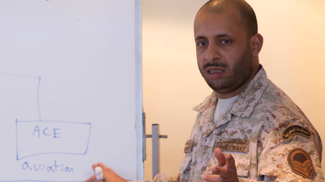 Kuwaiti Marine First Sgt. Bader M. Al-Hubaiter, an infantryman with the Kuwaiti Marine Battalion, explains the battalion’s organization to U.S. Marines with the Command Element and Logistics Combat Element, Special Purpose Marine Air-Ground Task Force – Crisis Response – Central Command during a Tactical Resupply Subject Matter Expert Exchange held at the Kuwait Naval Institute. Participants exchanged logistic concepts and best practices to learn from each other and strengthen relationships. Bader was recognized as one of the outstanding attendees of the course and received a command coin in recognition following the training.