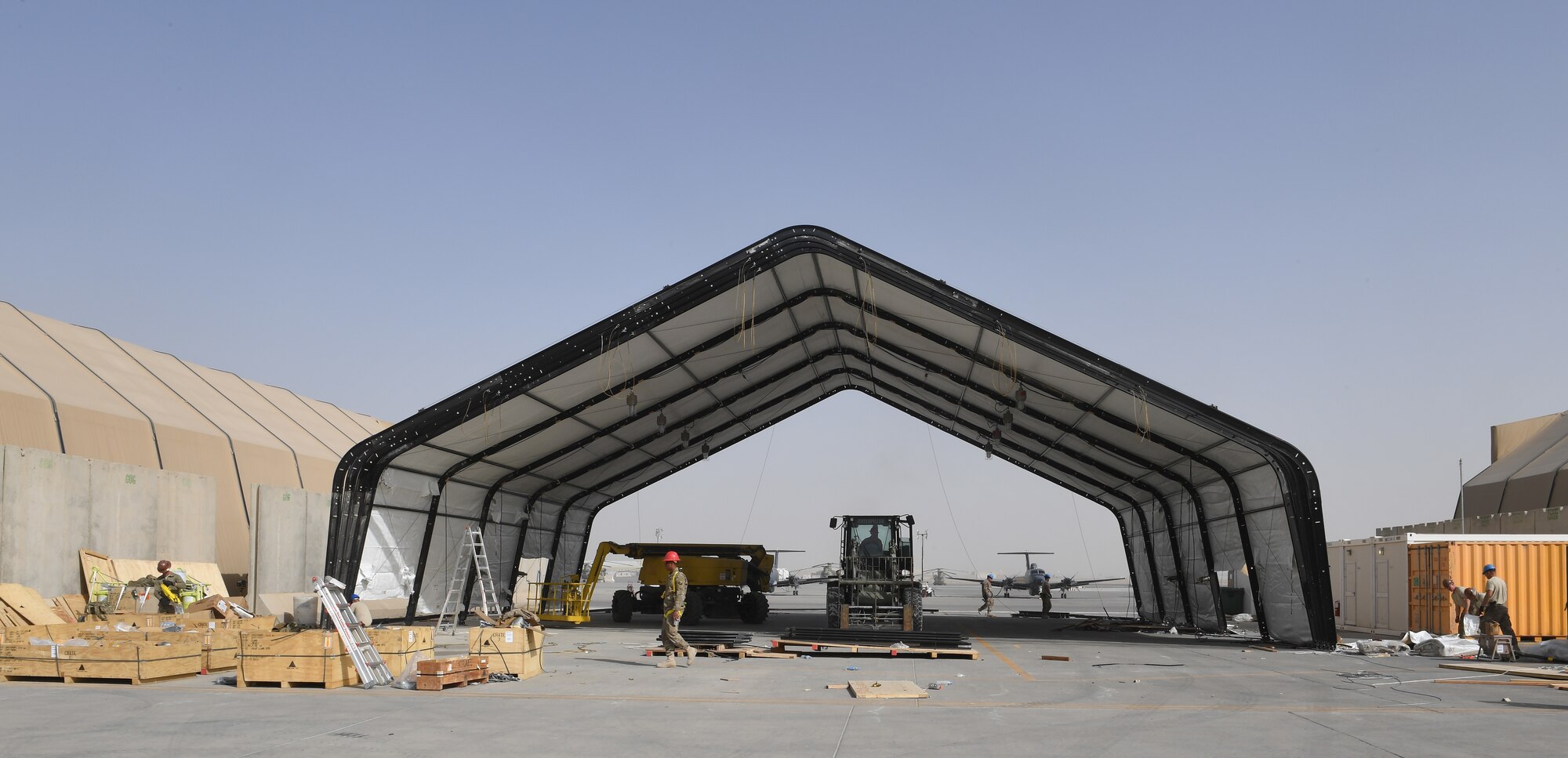 U.S. Air Force Airmen, assigned to the 577th Expeditionary Prime Base Engineer Emergency Force Group, build an aircraft hanger on Kandahar Airfield, Afghanistan, Dec. 27, 2017.