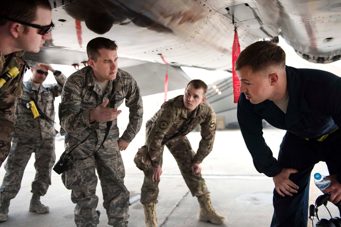 Air Force Staff Sgt. Schuler Edge briefs airmen on the safe operation of systems on the F-15E Strike Eagle aircraft.