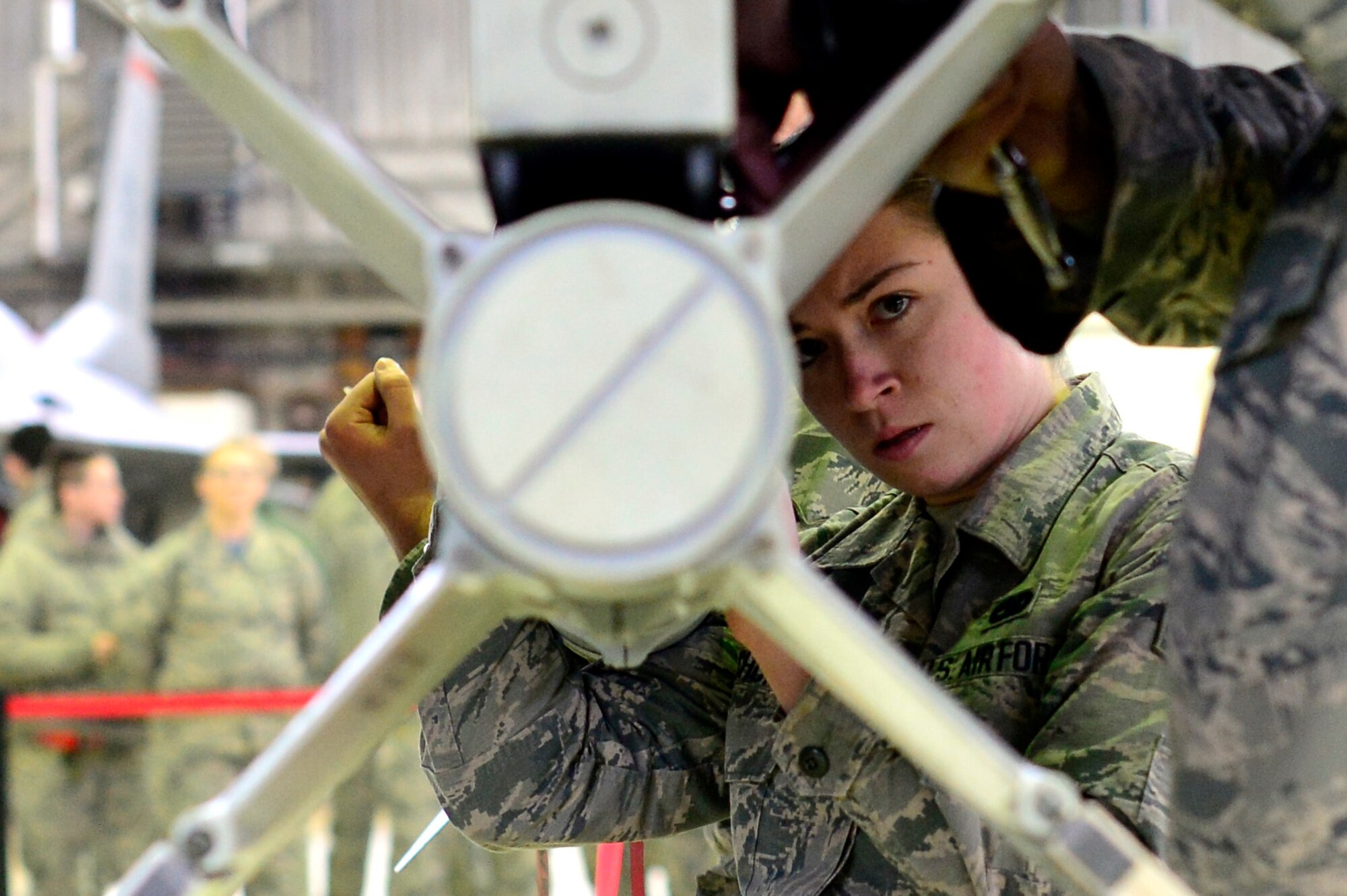 Senior Airman Haley Wolochowicz inspects a weapon for loading during a Weapons Load Crew Competition at Spangdahlem Air Base, Germany, Feb. 9, 2018. The competition featured two teams competing to be the wing’s best load crew and the winners will be announced at their annual Maintenance Professional of the Year banquet. (U.S. Air Force photo by Tech. Sgt. Staci Kasischke)