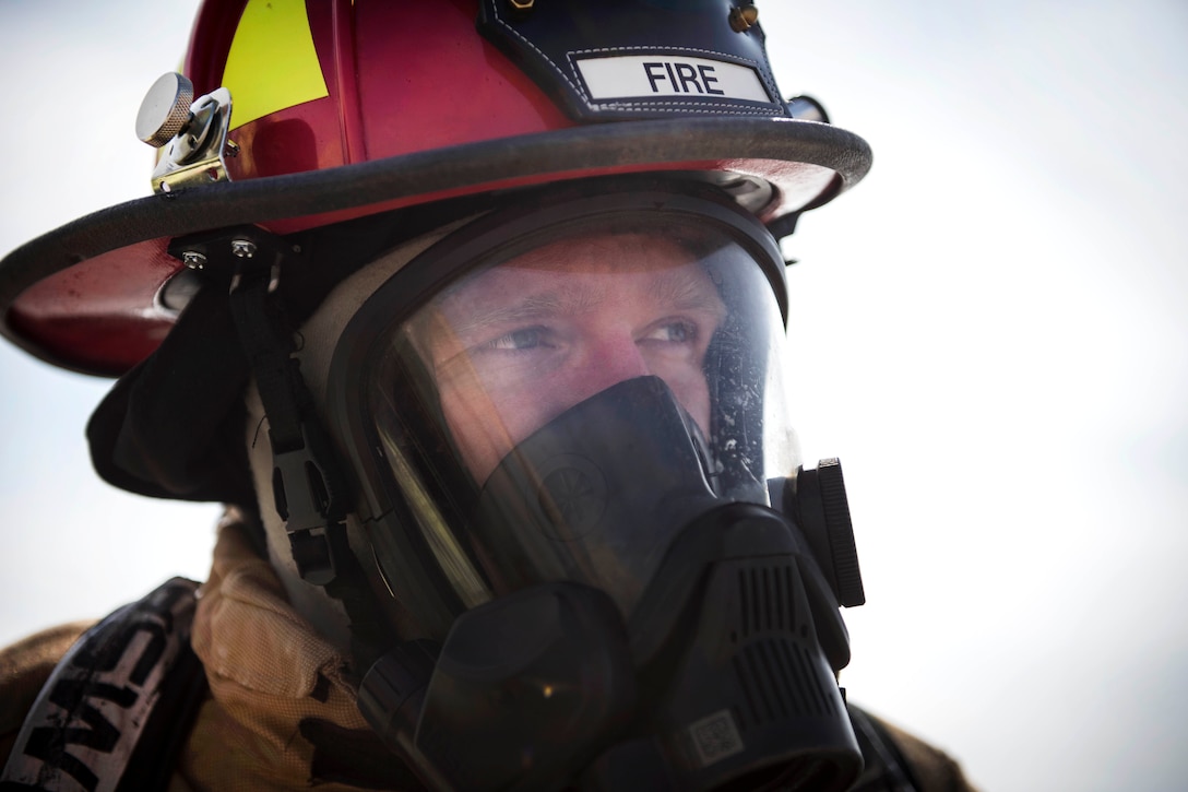 Air Force Tech Sgt. Kaleb Draper assesses a simulated incident scene during emergency egress training.