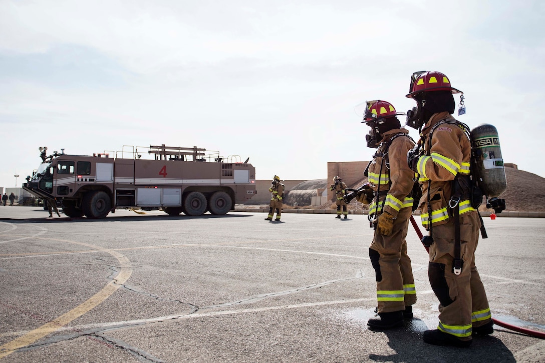 Air Force firefighters participate in an emergency aircraft egress training.