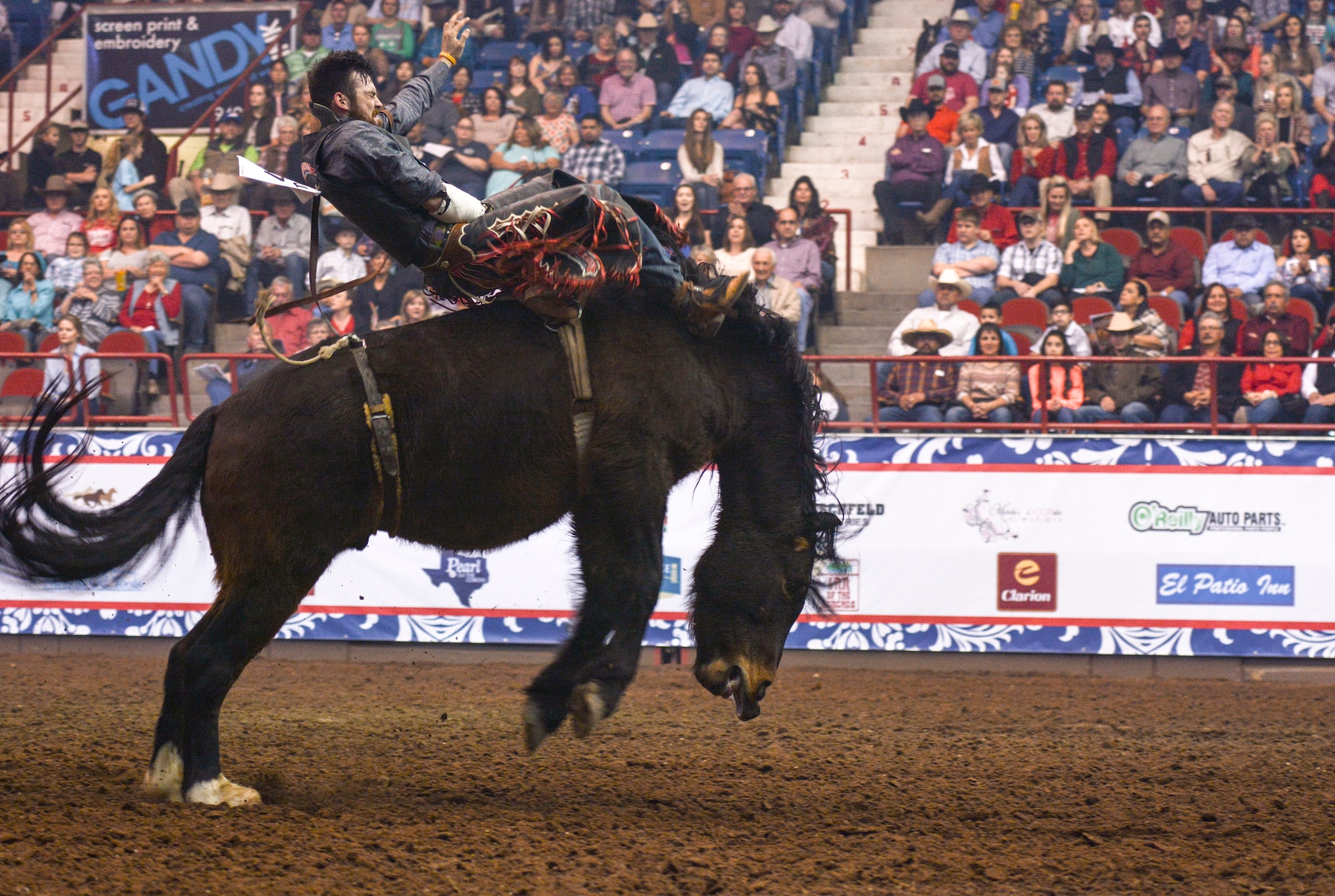 Logan Peterson rides bareback during Military Appreciation night at the San Angelo Stock Show and Rodeo held at the Foster Communications Coliseum, Feb. 14, 2018, in San Angelo, Texas. Bareback riding was the first event of the rodeo performance. (U.S. Air Force photo by Aryn Lockhart/Released)