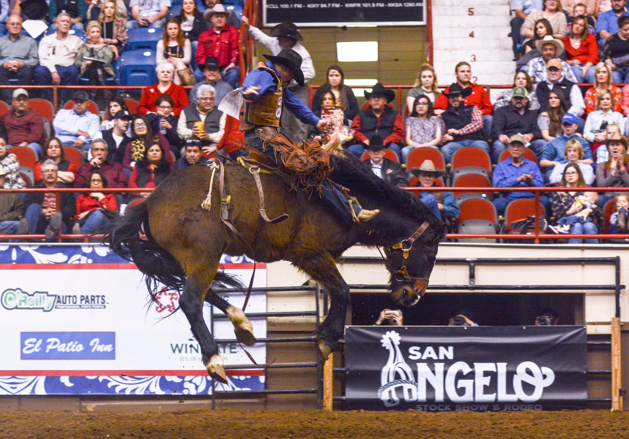 A rodeo cowboy holds tight during the saddle bronc riding event at the San Angelo Stock Show and Rodeo held at the Foster Communications Coliseum, Feb. 14, 2018, San Angelo, Texas. This year the rodeo celebrated 86 years in San Angelo. The rodeo is dedicated to preserving the western way of life and promoting agriculture education to the youth of Texas. (U.S. Air Force photo by Aryn Lockhart/Released)