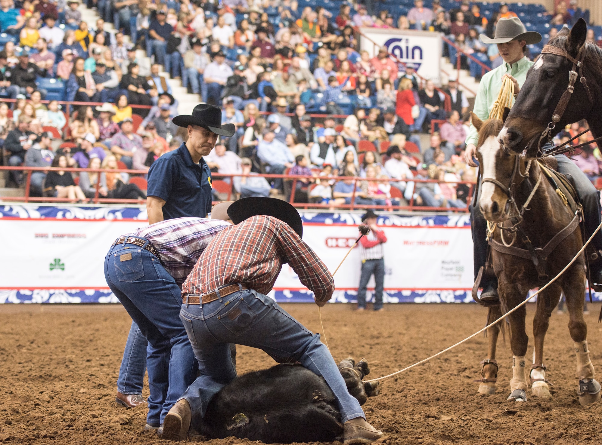 U.S. Air Force Col. Ricky Mills, 17th Training Wing commander, assists during the calf roping event during Military Appreciation Night at the San Angelo Stock Show and Rodeo held at the Foster Communications Coliseum, Feb. 14, 2018, San Angelo, Texas. The San Angelo Stock Show and Rodeo states this rodeo ranks fourth in the nation for livestock entries.  (U.S. Air Force photo by Aryn Lockhart/Released)
