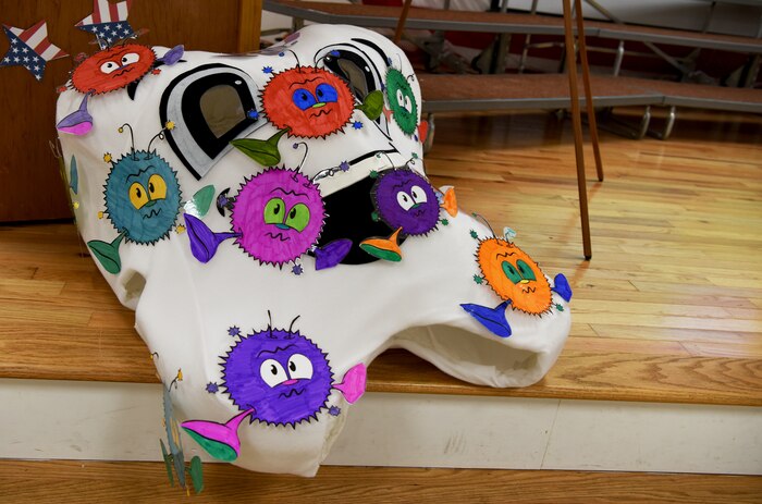 A tooth costume lies on stage during a visit from the 628th Medical Group Deily Dental Clinic staff workers to teach the importance of dental hygiene to Marrington Elementary School students Feb. 14, 2018, in South Carolina.