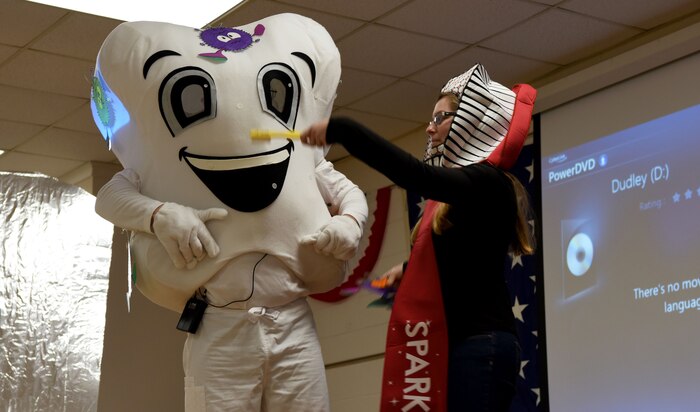 Patrick Miller, left, 628th Medical Group Deily Dental Clinic chief of preventative dentistry, and Staff Sgt. Kayla Ferguson, right, 628th MDG Deily Dental Clinic oral preventative assistant, perform a play for students at Marrington Elementary School during a school visit Feb. 14, 2018, in South Carolina.