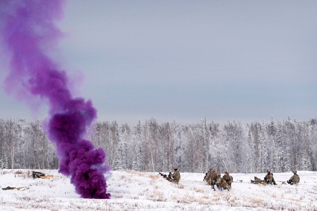 Purple smoke wafts upward in a field of snow as soldiers take positions nearby.