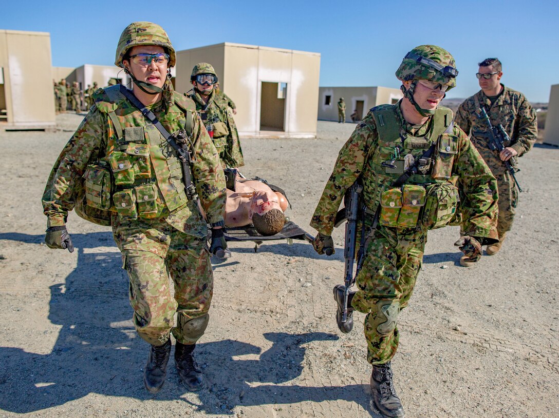 MARINE CORPS BASE CAMP PENDLETON, Calif. – Japan Ground Self Defense Soldiers run a simulated casualty to the pick up zone during exercise Iron Fist 2018, Jan. 22. Iron Fist is an annual, bilateral training exercise where U.S. and Japanese service members train together and share techniques, tactics and procedures to improve their combined operational capabilities. (U.S. Marine Corps photo by Cpl. Jacob A. Farbo)