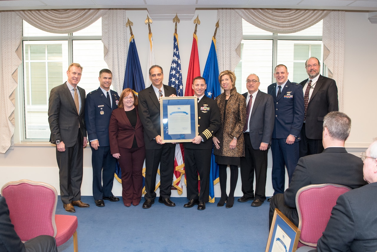 Deputy Defense Secretary Patrick M. Shanahan and Undersecretary of Defense for Acquisition, Technology and Logistics Ellen M. Lord, stand with members of the National Reconnaissance Office’s Low Earth Orbit System Program Office, which is among the four winning teams of the David Packard Excellence in Acquisitions Award during a ceremony at the Pentagon in Washington, Feb. 6, 2018. DoD photo by Army Sgt. Amber I. Smith