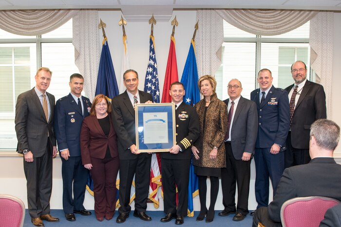 Deputy Defense Secretary Patrick M. Shanahan and the undersecretary of Defense for Acquisition, Technology and Logistics stand with members of the National Reconnaissance Office’s Low Earth Orbit System Program Office.
