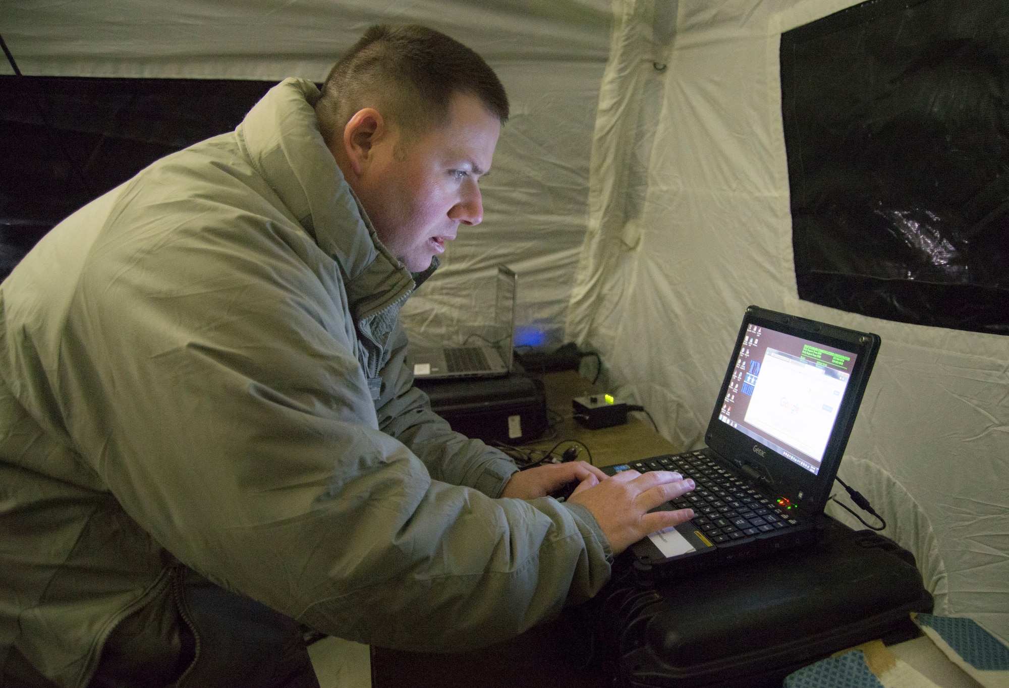 Tech. Sgt. Sean Newell, a radio frequency transmission systems technician, sets up a communication terminal during an aeromedical evacuation exercise Feb. 6, 2018, Scott Air Force Base, Illinois. The technicians use the terminal to access a secure website that allows for patient transport. He is with the 375th Communications Squadron but assigned to the 375th Aeromedical Evacuation Squadron as a member of the En-Route Patient Staging System team.  (U.S Air Force photo by Senior Airman Melissa Estevez)