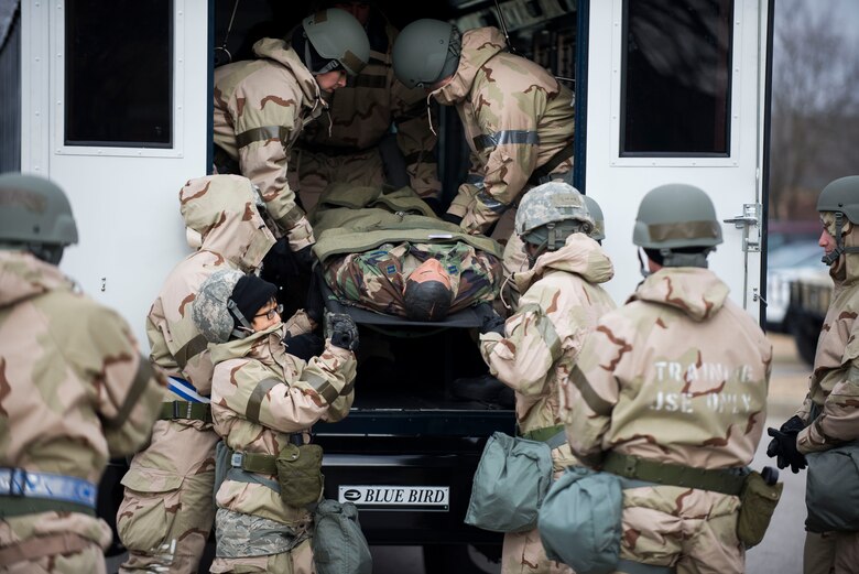 Members of the 375th Aeromedical Evacuation Squadron practice proper litter bearing techniques in Mission Oriented Protective Posture gear during an exercise at Scott Air Force Base, Illinois, Feb. 6, 2018. The exercise tested teh 375th AES's ability to perform under adverse conditions and ensured they are ready to operate in any situation. (U.S. Air Force photo by Staff Sgt. Clayton Lenhardt)