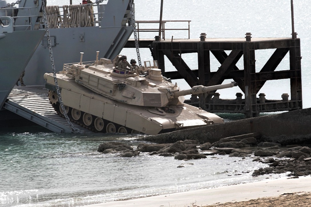 An M-1A1 Abrams Tank is offloaded onto the shore.