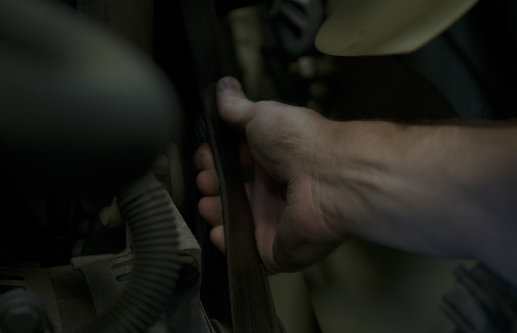 U.S. Air Force Senior Airman John Hipple, 628th Logistics Readiness Squadron, mission generation vehicular equipment maintenance journeyman, checks belt tension and wear on a vehicle in the LRS main shop Feb. 15.