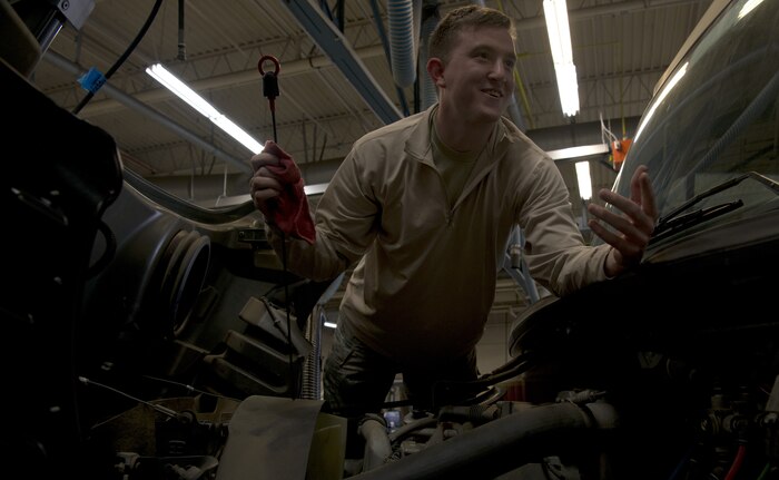 U.S. Air Force Senior Airman John Hipple, 628th Logistics Readiness Squadron, mission generation vehicular equipment maintenance journeyman, checks the transmission fluid on a vehicle in the LRS main shop Feb. 15.