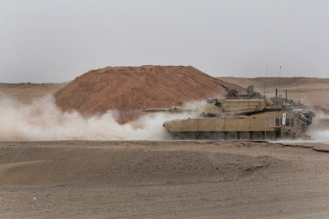 An M1A1 Abrams tank fires it’s main battle gun.