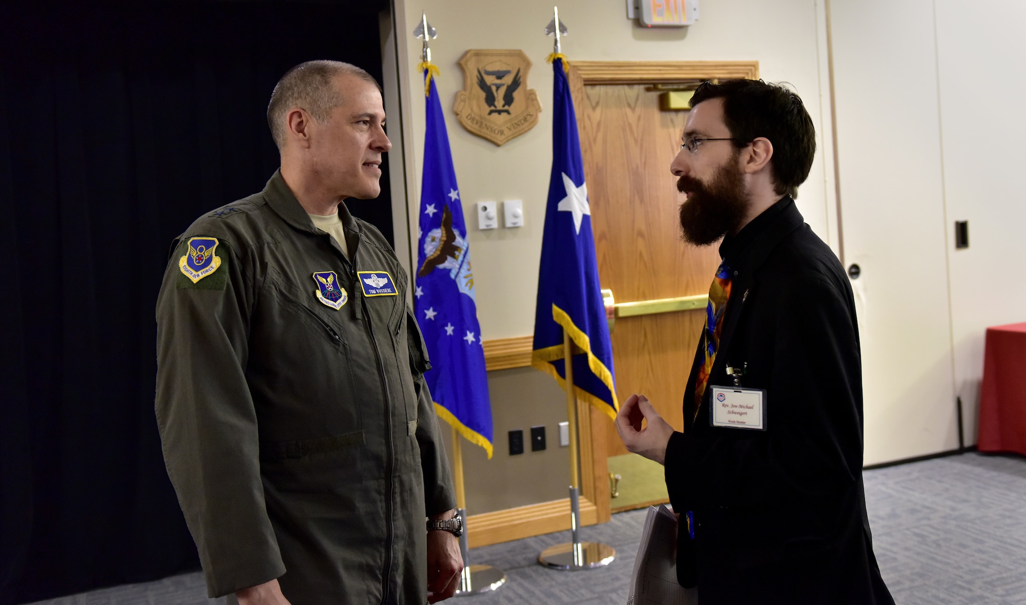 U.S. Air Force Maj. Gen. Thomas Bussiere, commander of the 8th Air Force, speaks with Rev. Jon-Michael Schweigert, the Knob Noster community liaison, following the monthly luncheon at Whiteman Air Force Base, Mo., Feb. 14, 2018.