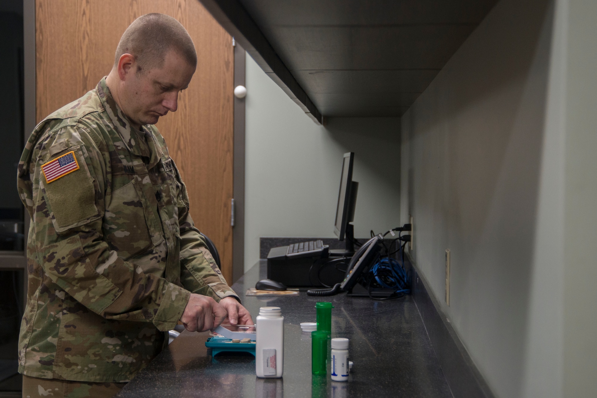 U.S. Army Staff Sgt. Gregory Beam, Scott Air Force Base Veterinary Treatment Facility NCO in charge, fills a prescription Feb. 12, 2018, at Scott AFB, Illinois. The vet clinic on base currently offer appointments for ill patients and patients needing vaccines, annual check-ups, and routine testing. (U.S. Air Force photo by Senior Airman Melissa Estevez)