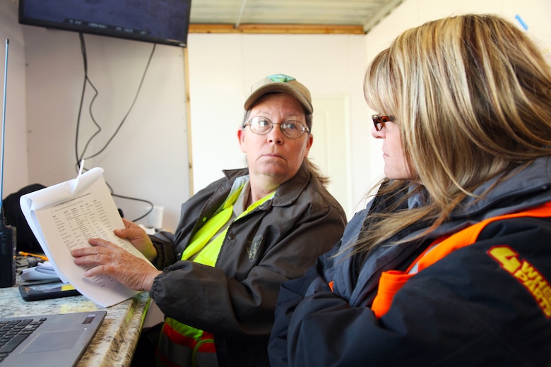 Katrina Symons, left, field manager, Bureau of Land Management Barstow, Calif., field office, discusses a race report with HammerKing Productions volunteer Dawn Rowe, Feb. 7, 2018. Rowe, who got involved with King of the Hammers in 2010 when she was Town of Yucca Valley mayor, takes leave from her job as Yucca Valley Congressman Paul Cook’s field representative each year to volunteer with HammerKing Productions as liaison between the race organizer, the BLM and other government agencies. King of the Hammers is the largest off-road racing and rock-crawling event in North America. (Marine Corps photo by Kelly O’Sullivan)