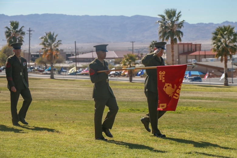 The company guidon and commander of D Company "Dragoons" lead the company in a pass in review during its deactivation ceremony aboard the Marine Corps Air Ground Combat Center, Twentynine Palms, Calif., Feb. 09, 2018. D Company was deactivated by order of the Commandant of the Marine Corps after 32 years of service. (U.S. Marine Corps photo by Lance Cpl. Preston L. Morris)