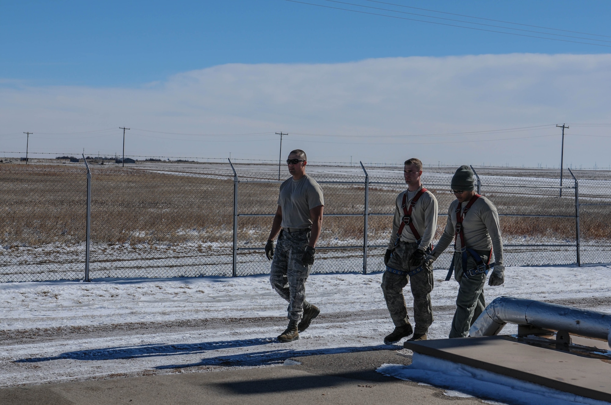 Airmen from the 90th Missile Maintenance Squadron walk onto a launch facility, Feb. 2, 2018, in the F.E. Warren Air Force Base missile complex. The 90th MMXS missile maintenance team earned the 2017 professional team of the year award for their constant professionalism in and out of the work place. Missile maintenance teams perform periodic maintenance to maintain the on-alert status for launch facilities, ensuring the success of the nuclear deterrence mission. (U.S. Air Force photo by Airman 1st Class Braydon Williams)