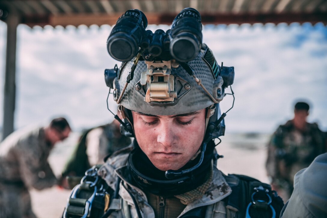 A Marine with 3rd Reconnaissance Battalion, 3rd Marine Division, III Marine Expeditionary Force prepares his gear at Marine Corps Air Ground Combat Center, Twentynine Palms, Calif., Feb. 13, 2018, as a part of Integrated Training Exercise 2-18. The purpose of ITX is to create a challenging, realistic training environment that produces combat-ready forces capable of operating as an integrated MAGTF. (U.S. Marine Corps Photo by Pfc. William Chockey)