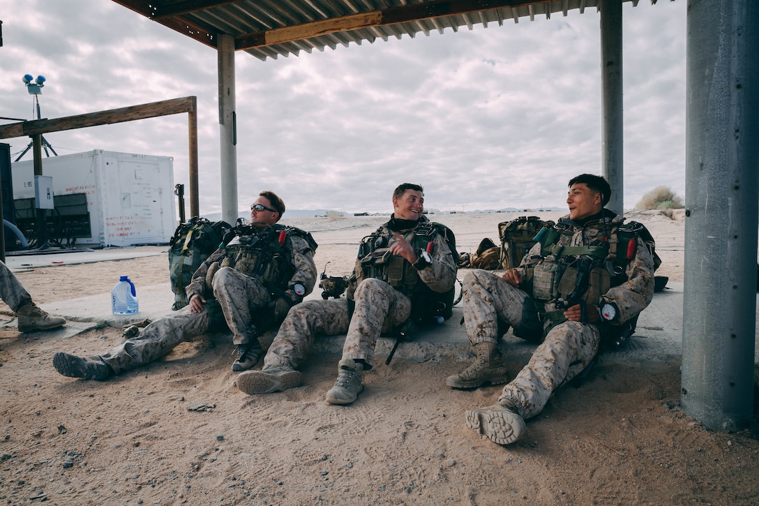 Marines with 3rd Reconnaissance Battalion, 3rd Marine Division, III Marine Expeditionary Force wait for a C130 Aircraft at the Air Combat Element landing strip  at Marine Corps Air Ground Combat Center, Twentynine Palms, Calif., Feb. 13, 2018, as a part of Integrated Training Exercise 2-18. The purpose of ITX is to create a challenging, realistic training environment that produces combat-ready forces capable of operating as an integrated MAGTF. (U.S. Marine Corps Photo by Pfc. William Chockey)