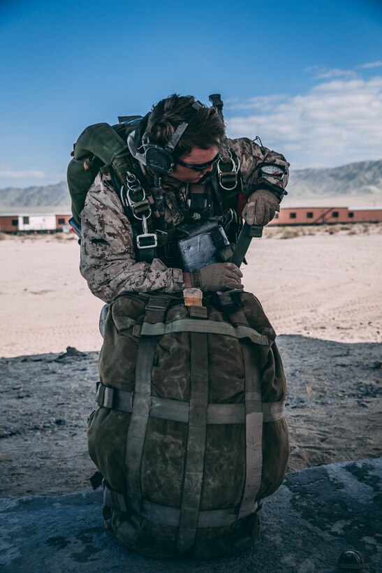 A Marine with 3rd Reconnaissance Battalion, 3rd Marine Division, III Marine Expeditionary Force prepares his gear at Marine Corps Air Ground Combat Center, Twentynine Palms, Calif., Feb. 13, 2018, as a part of Integrated Training Exercise 2-18. The purpose of ITX is to create a challenging, realistic training environment that produces combat-ready forces capable of operating as an integrated MAGTF. (U.S. Marine Corps Photo by Pfc. William Chockey)