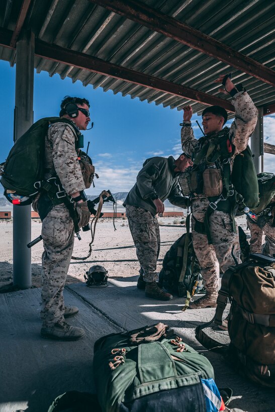 Marines with 3rd Reconnaissance Battalion, 3rd Marine Division, III Marine Expeditionary Force prepare their gear at Marine Corps Air Ground Combat Center, Twentynine Palms, Calif., Feb. 13, 2018, as a part of Integrated Training Exercise 2-18. The purpose of ITX is to create a challenging, realistic training environment that produces combat-ready forces capable of operating as an integrated MAGTF. (U.S. Marine Corps Photo by Pfc. William Chockey)