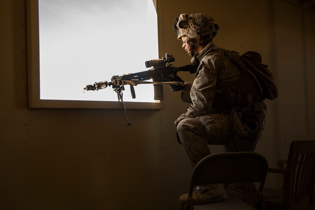 A Marine with 3rd Battalion, 7th Marine Regiment, posts security through a building window at Range 220 aboard the Marine Corps Air Ground Combat Center, Twentynine Palms Calif., Feb. 9, 2018 as part of Integrated Training Exercise 2-18. The purpose of ITX is to create a challenging, realistic training environment that produces combat-ready forces capable of operating as an integrated MAGTF. (U.S. Marine Corps photo by Lance Cpl. Margaret Gale)