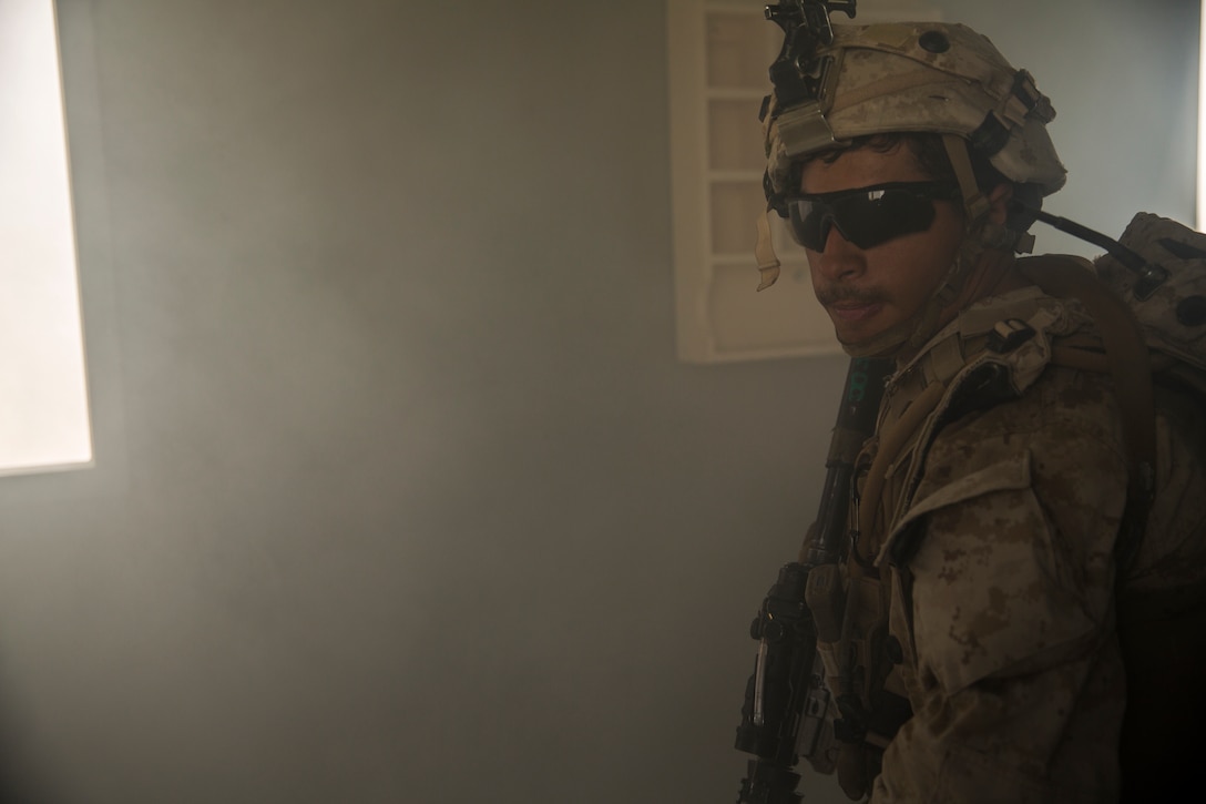 A Marine with 3rd Battalion, 7th Marine Regiment, clears a smoke-filled room at Range 220 aboard the Marine Corps Air Ground Combat Center Twentynine Palms, Calif., Feb. 9, 2018 as part of Integrated Training Exercise 2-18. The purpose of ITX is to create a challenging, realistic training environment that produces combat-ready forces capable of operating as an integrated MAGTF. (U.S. Marine Corps photo by Lance Cpl. Margaret Gale)
