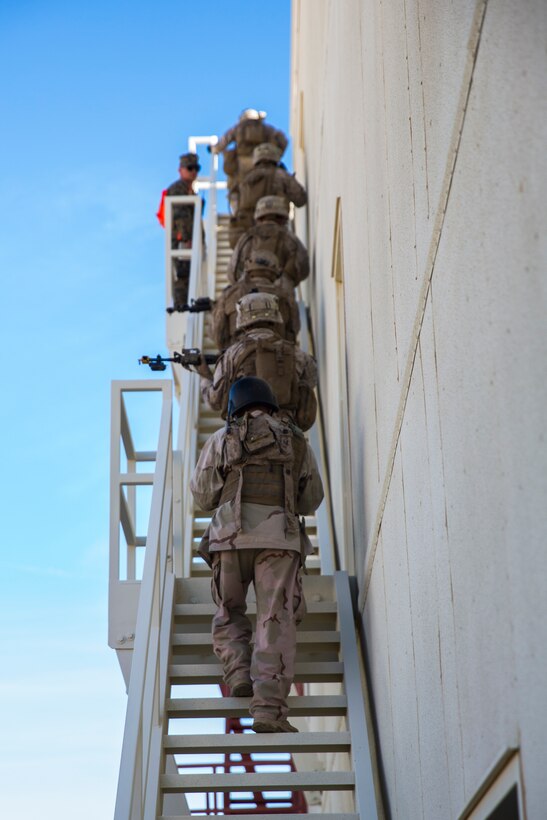 Marines with 3rd Battalion, 7th Marine Regiment, climb to the top of a building at Range 220 aboard the Marine Corps Air Ground Combat Center Twentynine Palms, Calif.,  Feb. 9, 2018 as part of Integrated Training Exercise 2-18. The purpose of ITX is to create a challenging, realistic training environment that produces combat-ready forces capable of operating as an integrated MAGTF. (U.S. Marine Corps photo by Lance Cpl. Margaret Gale)