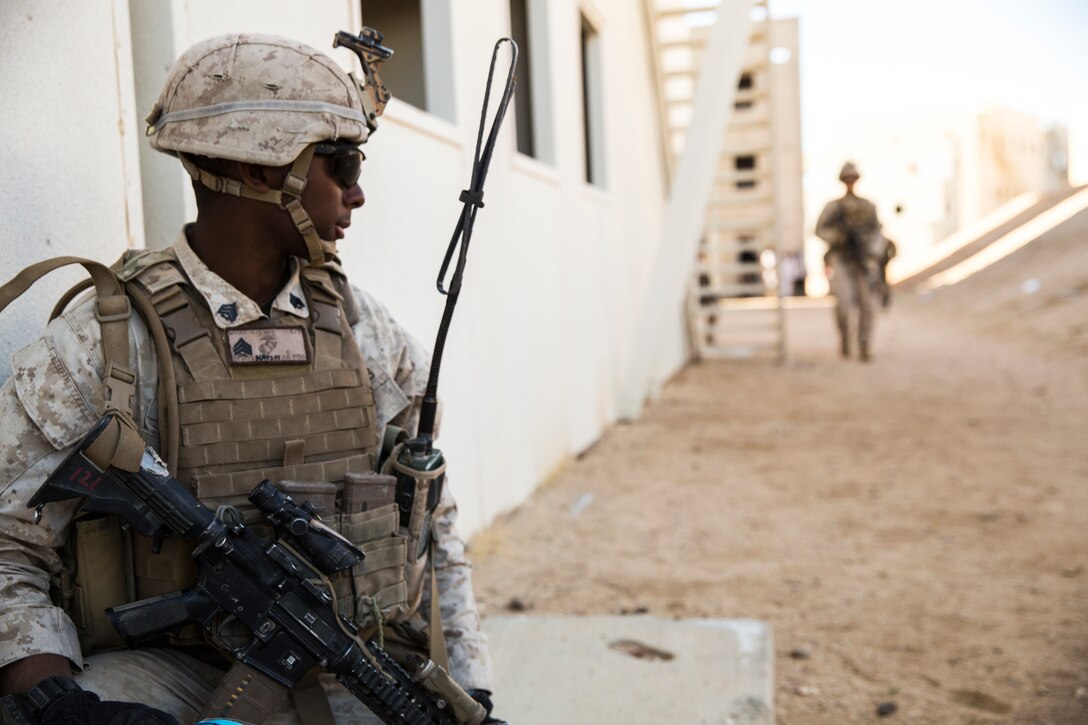 Sgt. Kevin Moore, squad leader, 3rd Battalion, 7th Marine Regiment, calls for a Marine to give orders at Range 220 aboard the Marine Corps Air Ground Combat Center Twentynine Palms, Calif., Feb. 9, 2018 as part of Integrated Training Exercise 2-18. The purpose of ITX is to create a challenging, realistic training environment that produces combat-ready forces capable of operating as an integrated MAGTF. (U.S. Marine Corps photo by Lance Cpl. Margaret Gale)