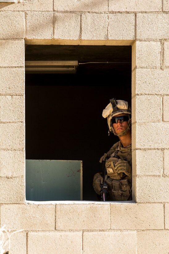 Lance Cpl. Cade Khademi, team leader, 3rd Battalion, 7th Marine Regiment, listens to commands from a distant building at Range 220 aboard the Marine Corps Air Ground Combat Center, Twentynine Palms, Calif.,  Feb. 9, 2018 as part of Integrated Training Exercise 2-18. The purpose of ITX is to create a challenging, realistic training environment that produces combat-ready forces capable of operating as an integrated MAGTF. (U.S. Marine Corps photo by Lance Cpl. Margaret Gale)