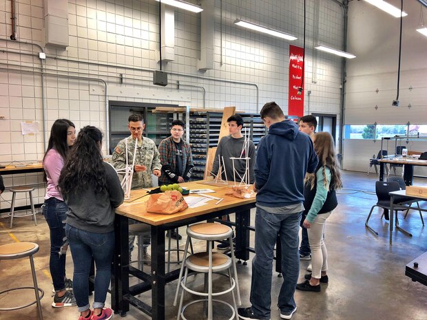 Army Cpt. Brent Vance explains the concept of tension and compression to students at College Place High School, in College Place, WA. Middle and High School students from College Place, Walla Walla and Pendleton will be participating in the U.S. Army Corps of Engineers, Engineer Week (EWeek) competition “Towering above the Imagination.” From February 20th to the 26th engineers from Corps districts are in the classrooms introducing engineering concepts to students and teachers, using hands-on projects to connect them to real-world careers in STEM.