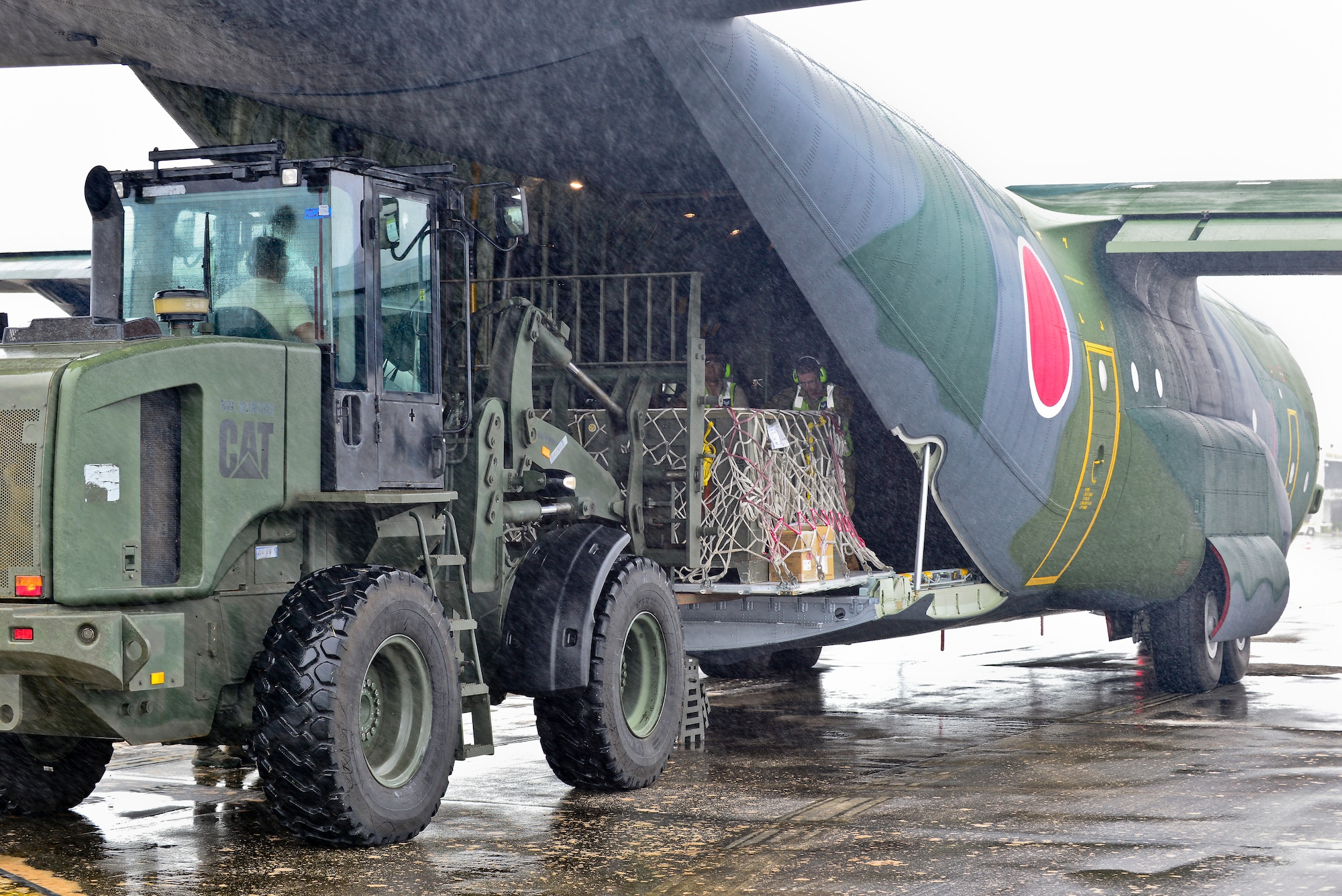 U.S. Air Force and Royal Australian Air Force humanitarian assistance/disaster relief personnel unload a Koku Jieitai (Japanese Air Self-Defense Force) C-130H Hercules in support of exercise COPE NORTH 2018 at Rota, U.S. Commonwealth of the Northern Mariana Islands, Feb. 17. An annual exercise, this year's COPE NORTH is a multilateral HA/DR exercise that allows participating nations to prepare for and recover from the devastating effects of natural disasters. (U.S. Air Force photo by Airman 1st Class Christopher Quail)
