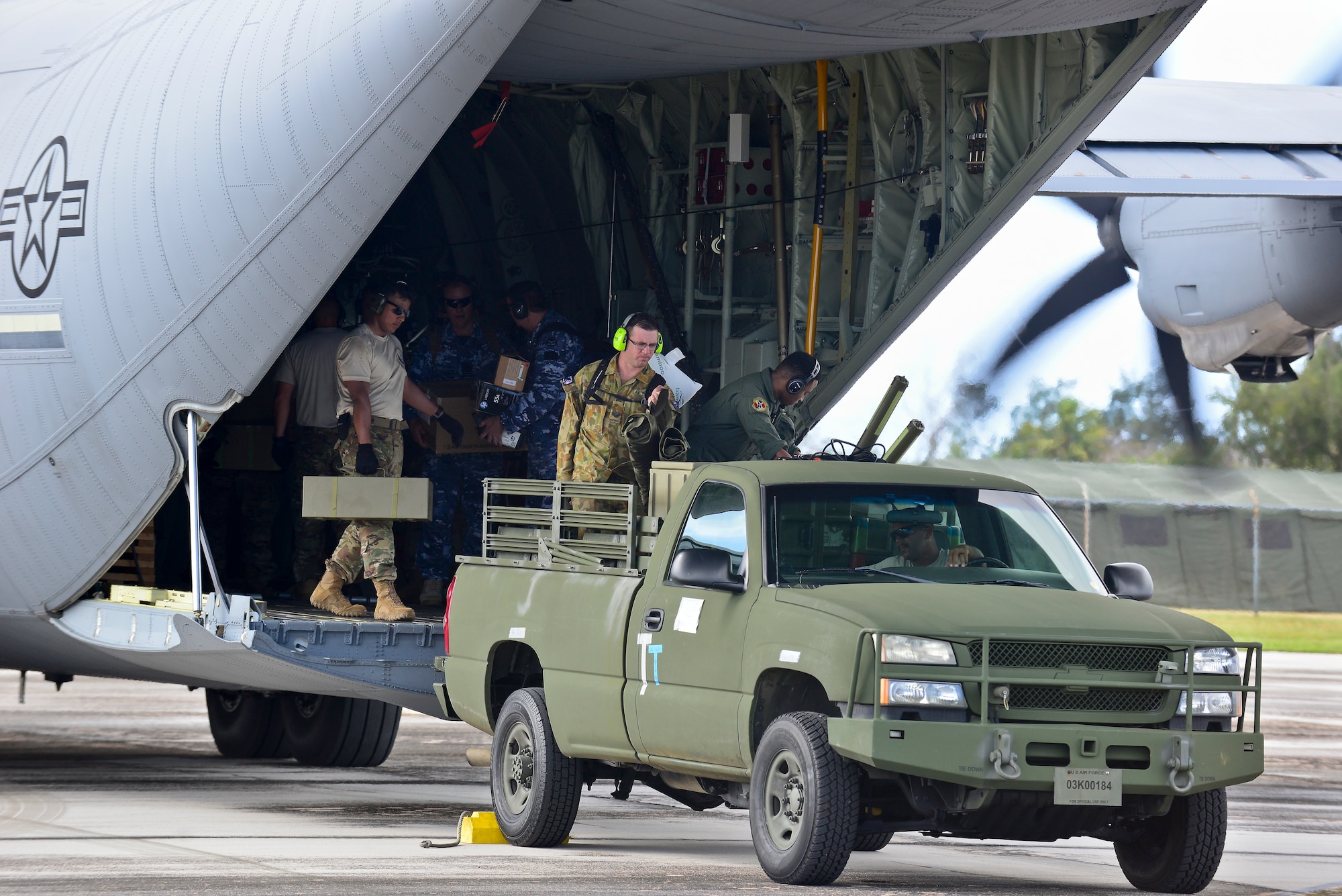 U.S. Air Force and Royal Australian Air Force humanitarian assistance/disaster relief (HA/DR) participants unload a USAF C-130J Super Hercules during exercise COPE NORTH 2018 at Rota, U.S. Commonwealth of the Northern Mariana Islands, Feb. 17. An annual exercise, this year's COPE NORTH is a multilateral HA/DR exercise that allows participating nations to prepare for and recover from the devastating effects of natural disasters. (U.S. Air Force photo by Airman 1st Class Christopher Quail)