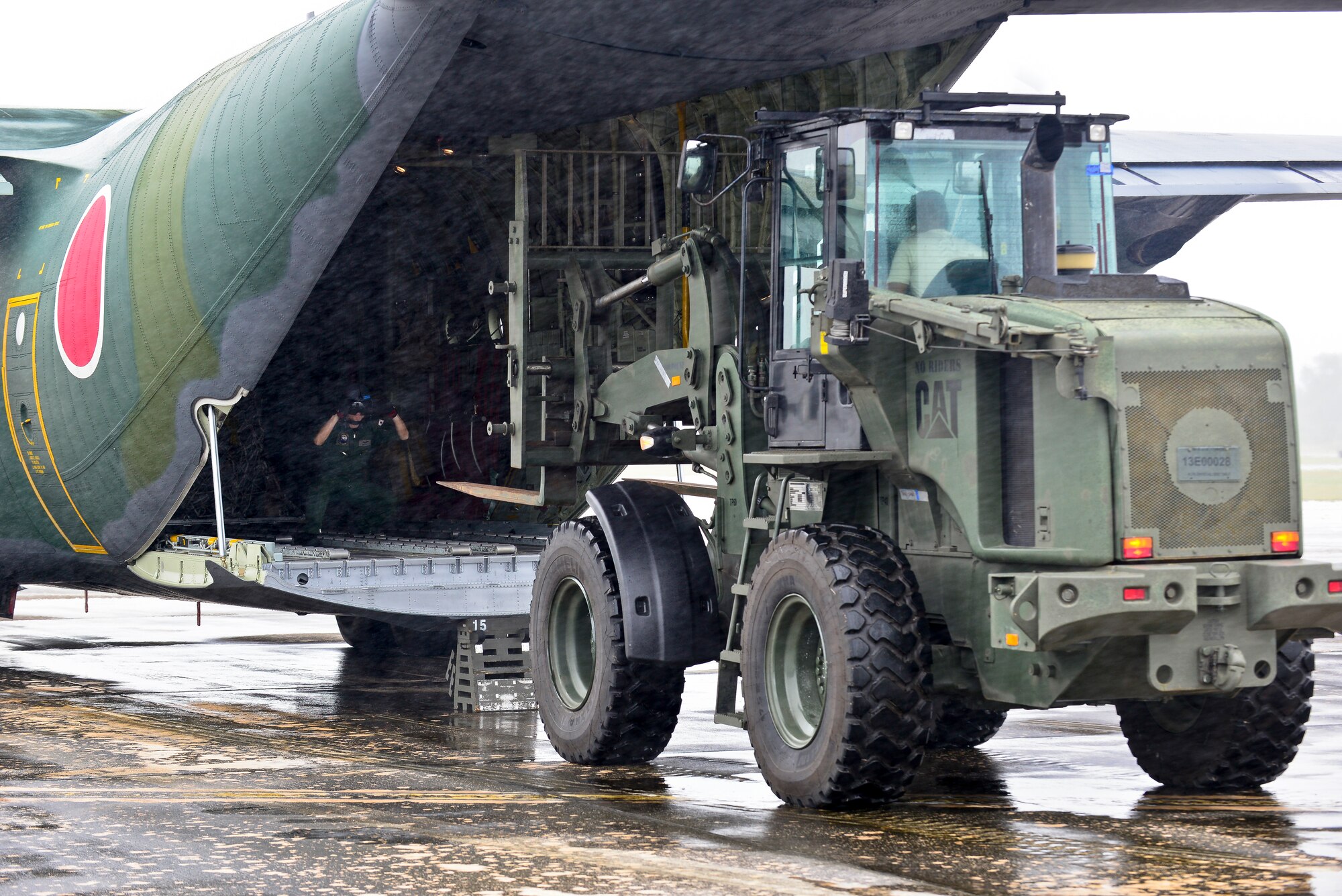U.S. Air Force and Koku Jieitai (Japanese Air Self-Defense Force) humanitarian assistance/disaster relief personnel unload a Koku Jieitai C-130H Hercules in support of exercise COPE NORTH 2018 at Rota, U.S. Commonwealth of the Northern Mariana Islands, Feb. 17. An annual exercise, this year's COPE NORTH is a multilateral HA/DR exercise that allows participating nations to prepare for and recover from the devastating effects of natural disasters. (U.S. Air Force photo by Airman 1st Class Christopher Quail)
