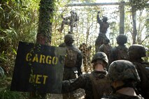 Marines with Communications Company, Headquarters Regiment, 3rd Marine Logistics Group climb over the cargo net, one of the obstacles in the Endurance Course at Camp Gonsalves, Okinawa, Japan, Feb. 16, 2018. The E-Course is the culminating event in the Basic Jungle Skills Course, consisting of obstacles scattered through the hill-riddled jungle. BJSC is designed to teach Marines how to operate in a jungle environment. (U.S. Marine Corps photo by Lance Cpl. Jamin M. Powell)