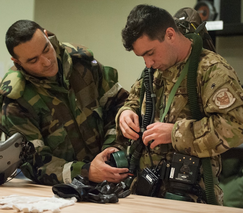 Aircrew conduct inflight training with protective gear > Air Force