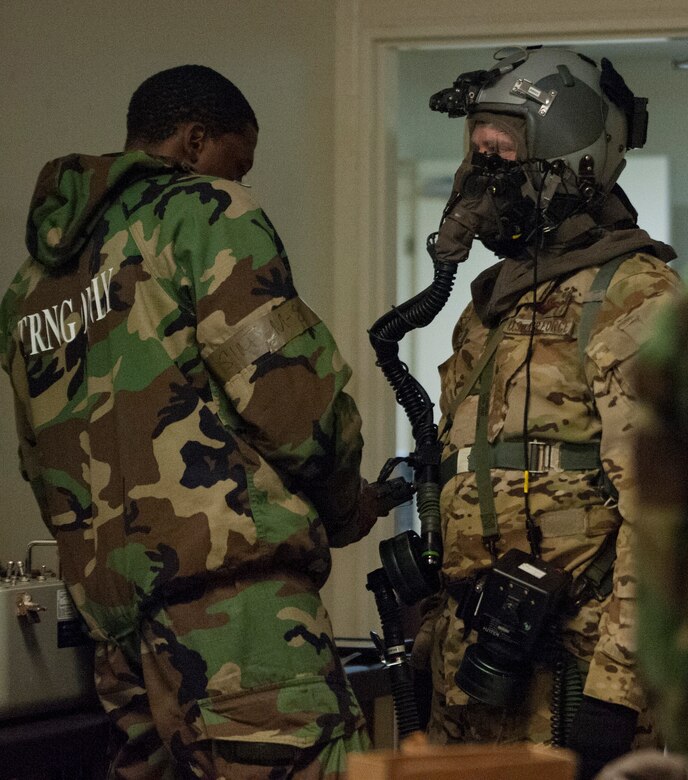 Aircrew conduct inflight training with protective gear > Air Force